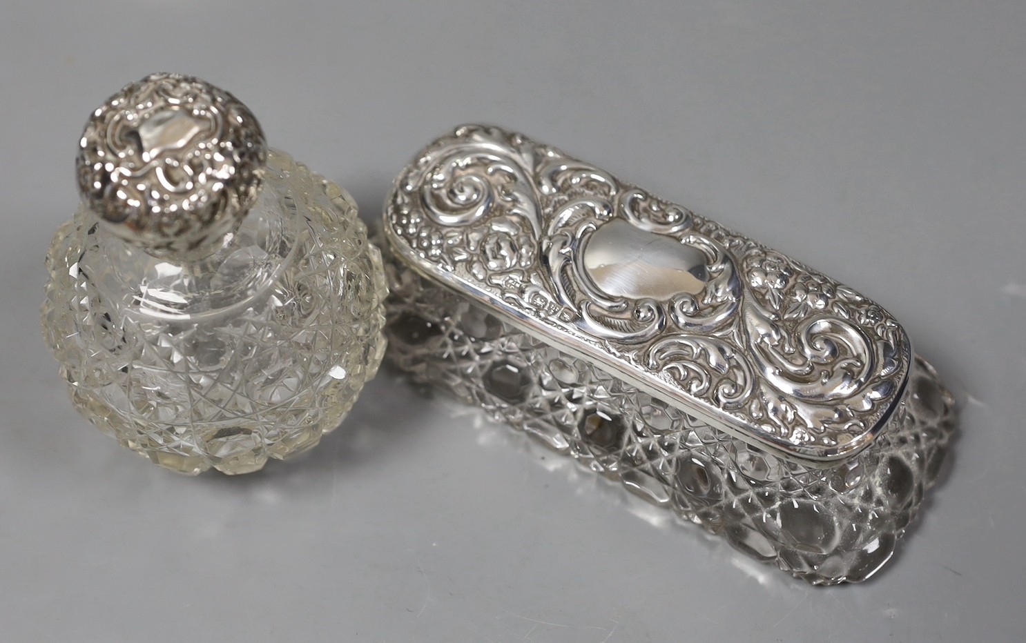 An Edwardian silver two handled posy vase, 13.7cm, a silver mounted glass scent bottle and three similar toilet jars.